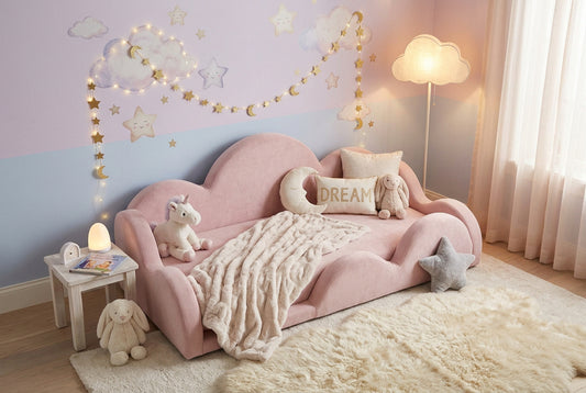 A pink cloud-shaped toddler bed with a white mattress, shown from the front against a plain white background.